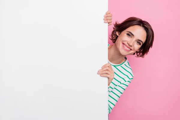 Portrait of attractive cheerful friendly girl holding large copy blank space banner isolated over pink pastel color background — Stock Photo, Image