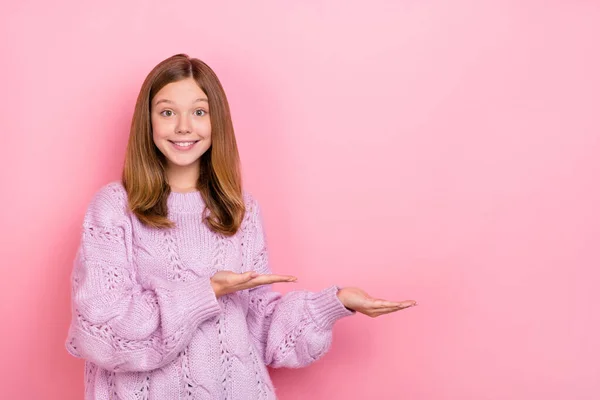 Φωτογραφία από χαριτωμένο γοητευτικό κορίτσι πλέκει πουλόβερ εκμετάλλευση βραχίονες κενό χώρο απομονωμένο ροζ χρώμα φόντο — Φωτογραφία Αρχείου