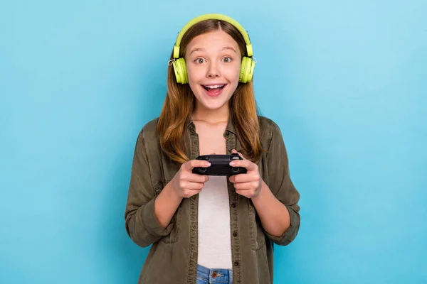 Foto de funky positivo louco alegre pouco senhora jogo viciado desgaste causal adolescente isolado no fundo de cor azul — Fotografia de Stock