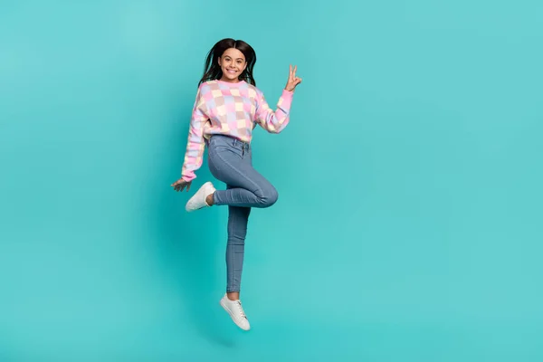 Full length body size view of attractive cheery funny girl jumping showing v-sign good mood isolated on shine teal turquoise color background — Stockfoto