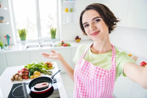 Photo of pretty person take selfie recording video hand palm demonstrate frying fresh trout kitchen indoors — Stock Photo, Image