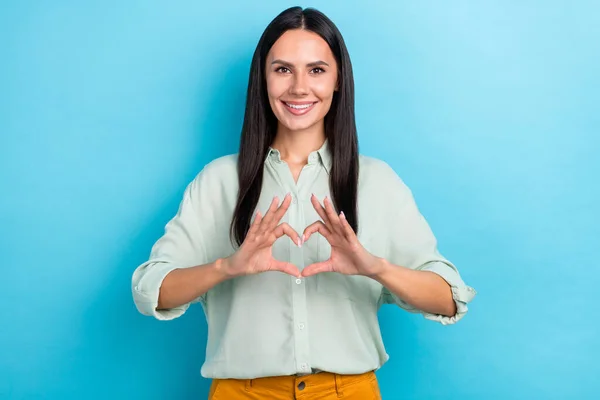 Foto de jovem mulher bonita mostrar dedos forma de coração cupido romântico isolado sobre fundo de cor azul — Fotografia de Stock