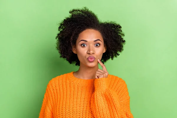 Foto de flirty millennial volumen peinado señora golpe beso desgaste naranja jersey aislado sobre fondo de color verde — Foto de Stock