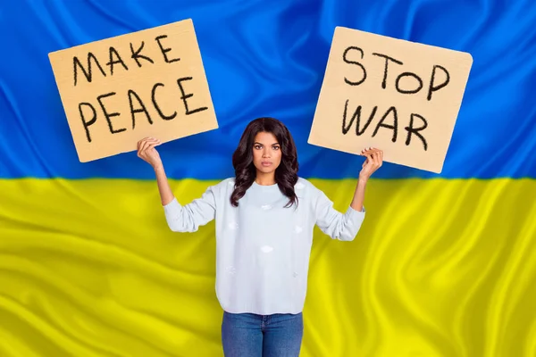 Young activist girl stand central square strike support Ukraine civilians government ask EU NATO close sky isolated in front of yellow blue colors background