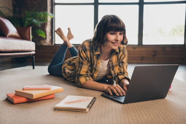 Photo of charming intelligent girl surfing internet make notes homework prepare for lesson in college lying floor in comfy flat — Stock Photo, Image