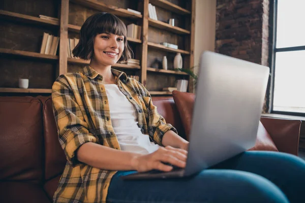 Photo of pretty adorable business lady wear checkered shirt working modern device sitting couch indoors workshop — Stock Photo, Image