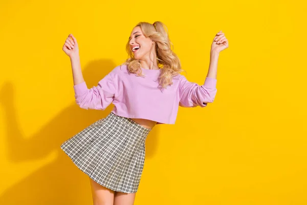 Photo of overjoyed satisfied girl clubbing spend free time isolated on yellow color background — Stock Photo, Image