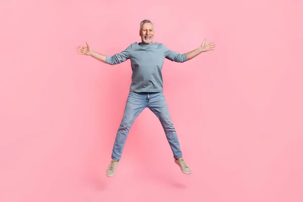 Full length body size view of attractive cheerful grey-haired man jumping having fun isolated over pink pastel color background — Stock Photo, Image