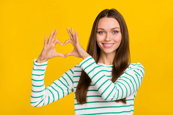 stock image Photo of pretty cute woman wear striped shirt showing arms heart isolated yellow color background