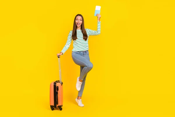 Full length photo of young excited girl rejoice vacation fly tourism holiday isolated over yellow color background — Stock Photo, Image