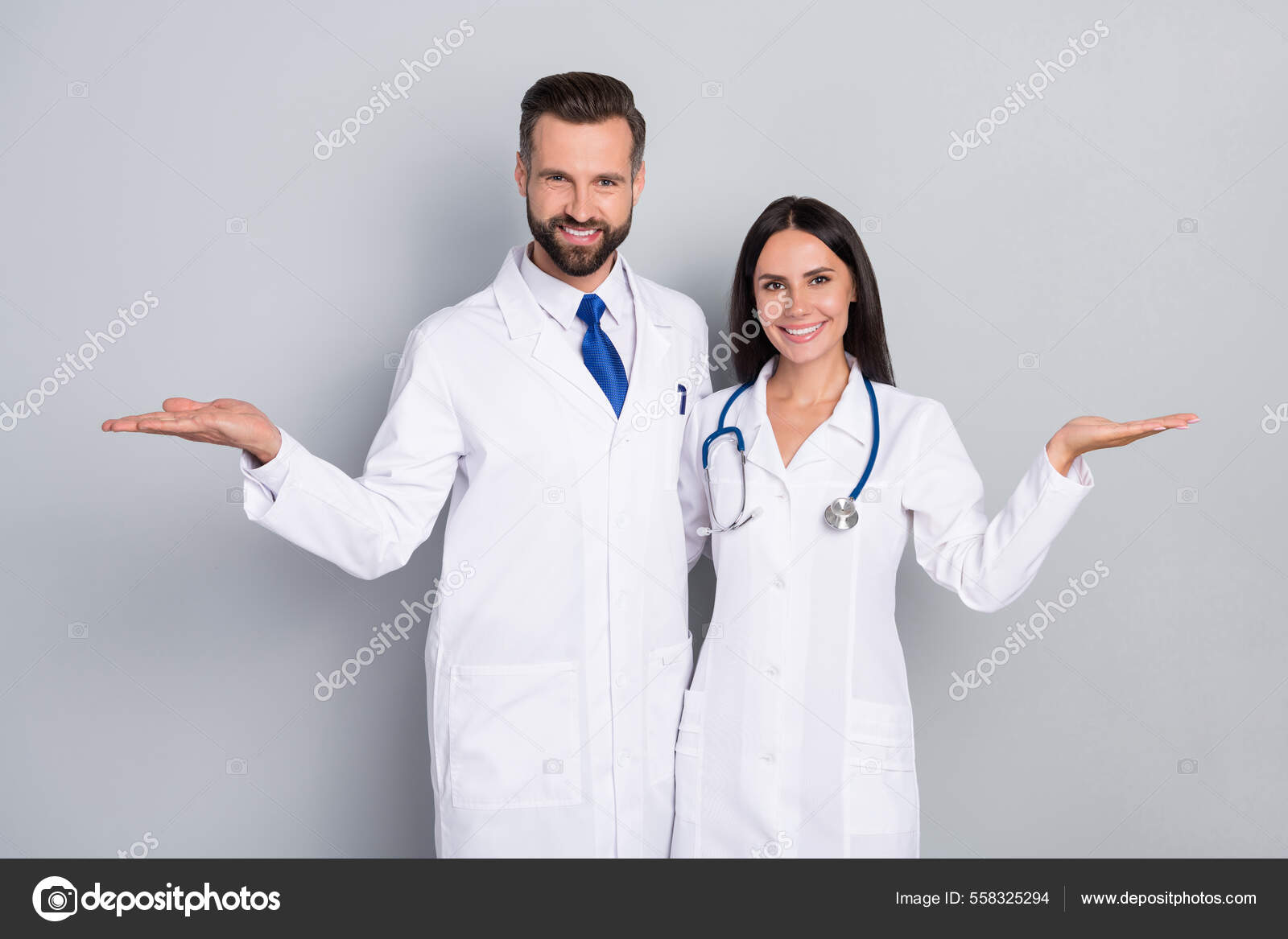 Photo Of Pretty Happy Two Doctors Wear White Coats Comparing Arms Empty photo-of-pretty-happy-two-doctors-wear-white-coats-comparing-arms-empty