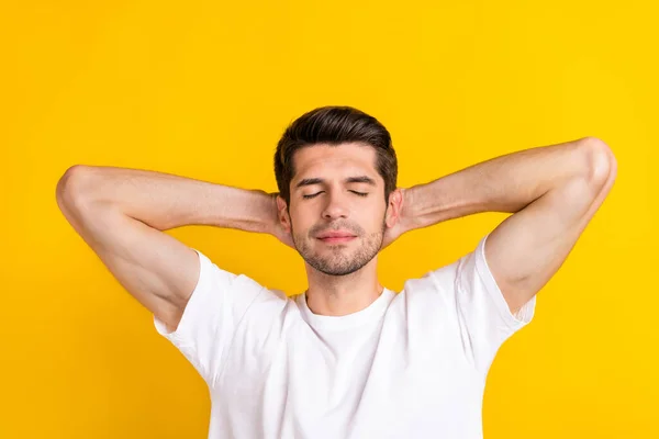 Photo of nice young brunet guy palms head wear white t-shirt isolated on yellow color background — Stockfoto