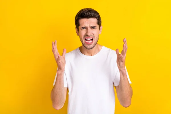 Photo of angry furious crazy annoyed man argue conflict concept wear white t-shirt isolated yellow color background —  Fotos de Stock