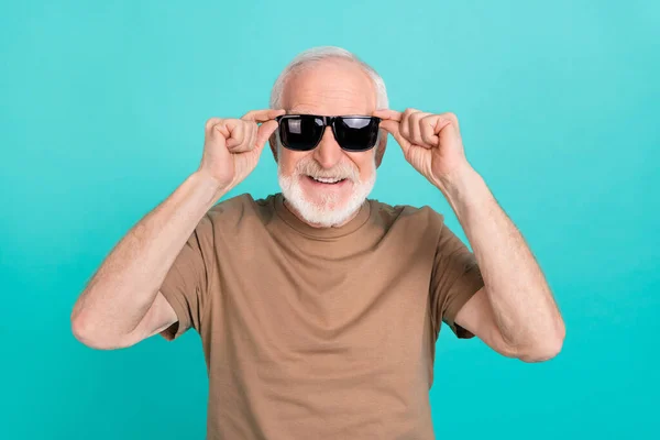 Portrait of attractive cheerful funky grey-haired man touching specs good mood isolated over bright blue color background — Stock Photo, Image