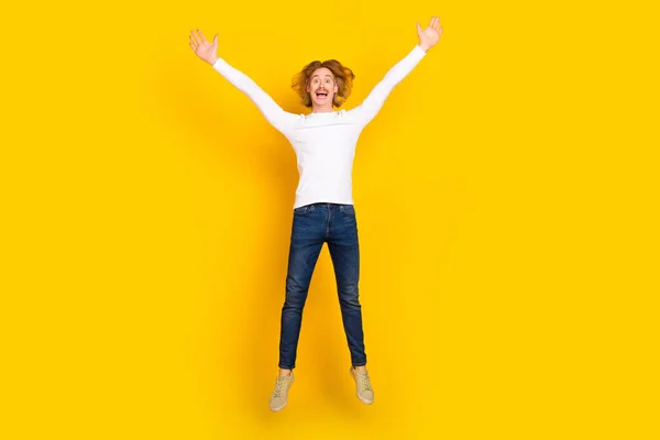 Full size photo of funny rejoice careless male jumping up fooling around relaxing on holiday isolated on yellow color background — Stock Photo, Image