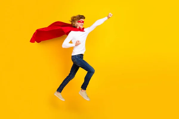 Full size profile side photo of carefree playful male in superman costume childish behavior isolated on yellow color background — Stock Photo, Image