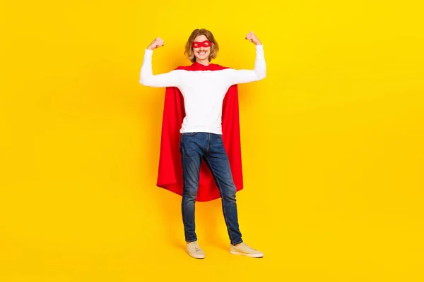 Photo of lucky strong guy wear white shirt superhero outfit rising fists isolated yellow color background — Stock Photo, Image