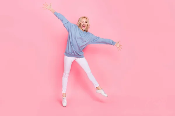 Full length photo of young excited pretty girl have fun jump up travel isolated over pink color background — Stock Photo, Image