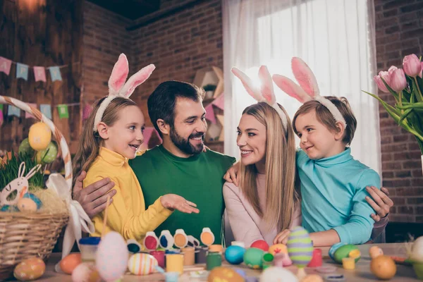 Retrato de atraente engraçado alegre família esposa marido colorir ovos criativo arte abraço abraçar passatempo dentro de casa — Fotografia de Stock