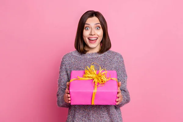 Photo of charming impressed lady dressed sweater earphones getting present box isolated pink color background