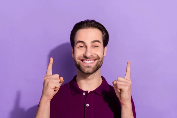 Porträt von hübschen fröhlichen männlichen Zeigefinger nach oben leeren Raum fördern Produkt isoliert auf violettem Hintergrund — Stockfoto