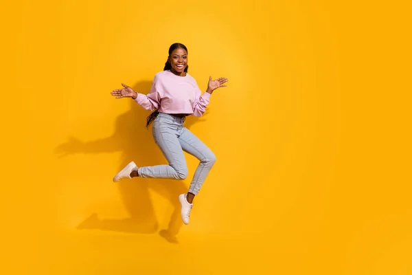 Full length photo of overjoyed cheerful girl raise arms palms isolated on yellow color background — ストック写真