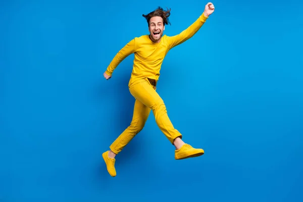 Full length body size view of attractive cheerful guy jumping having fun isolated over bright blue color background — Stock Photo, Image