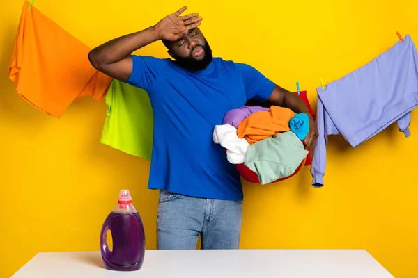 Retrato de bonito na moda exausto cara mão lavar roupa na tigela duro isolado sobre fundo de cor amarelo brilhante — Fotografia de Stock