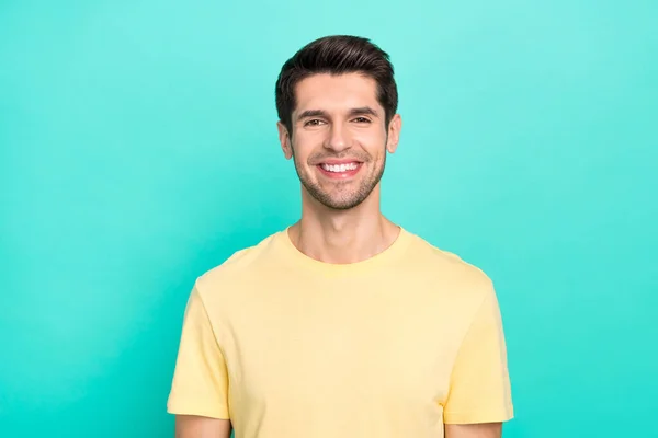 Photo of cute brunet young guy wear yellow t-shirt isolated on turquoise color background — Stock Photo, Image