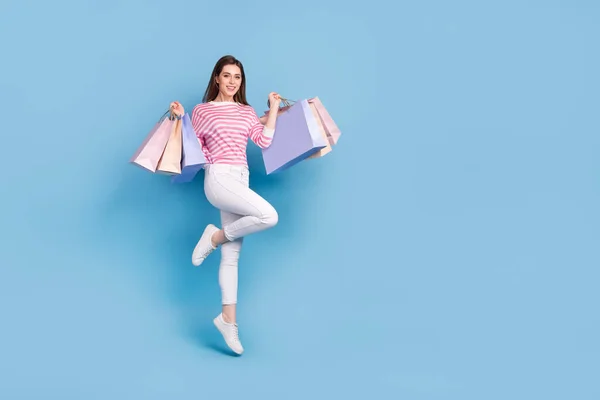 Full body portrait of excited satisfied person hold packages isolated on blue color background — ストック写真