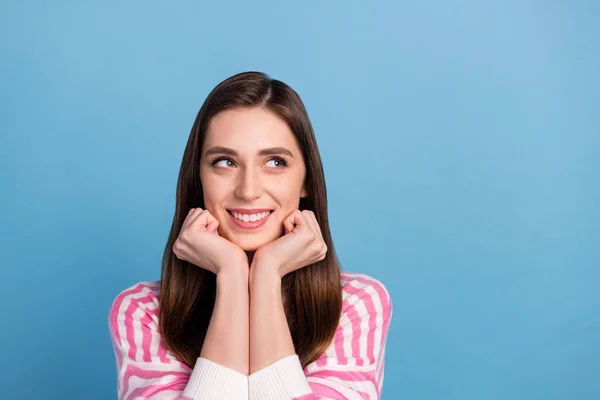 Portrait of minded positive lady hands cheeks look interested empty space isolated on blue color background — Stock Photo, Image