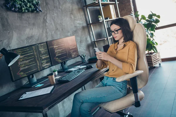 Photo of focused intelligent hardware expert sitting chair use telephone write typing office indoors — ストック写真