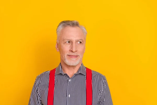 Портрет привабливого змісту сіро-волохатого чоловіка, який дивиться вбік копіювати простір ізольовано на блискучому жовтому кольоровому фоні — стокове фото