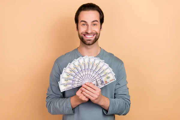 Photo of young cheerful man wealthy win lottery ecstatic benefit profit isolated over beige color background — Stock Photo, Image