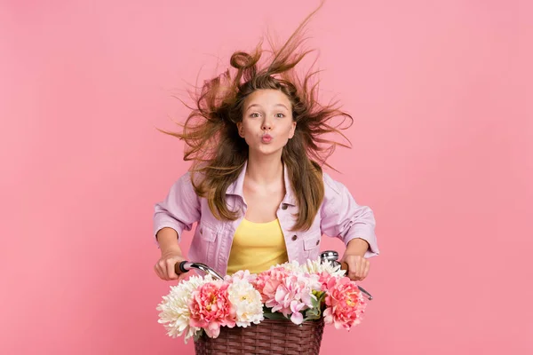 Foto de muito romântico senhora passeio bicicleta vento sopro cabelo enviar ar beijo desgaste casaco isolado cor-de-rosa fundo — Fotografia de Stock