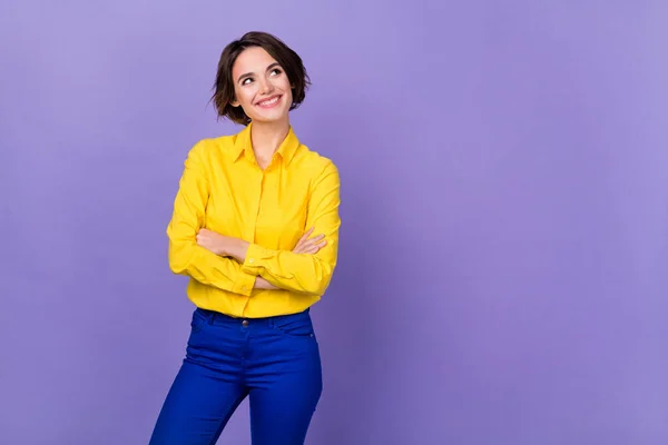 Photo of sweet young brunette lady crossed arms look promo wear yellow shirt isolated on purple color background — Stock Photo, Image