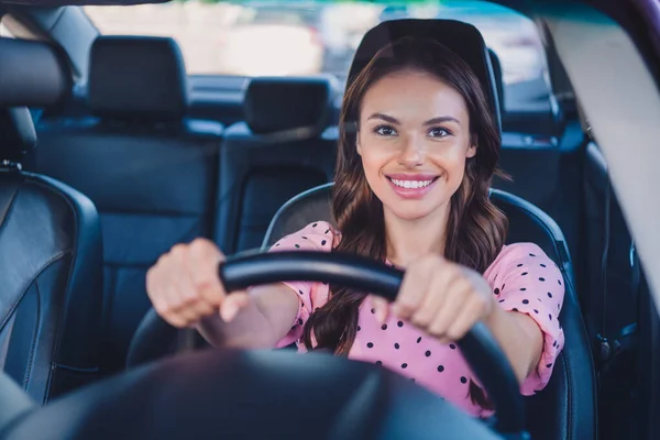 Photo of young lovely woman ride automobile transport vacation arms on steering wheel road speed outdoors — Stock Photo, Image