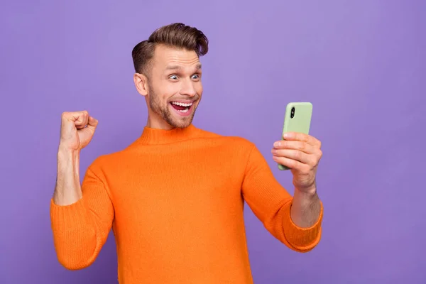 Photo of cheerful overjoyed ecstatic man laughing screaming win lottery giveaway isolated on violet color background — ストック写真