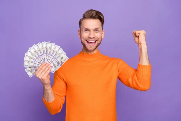 Portrait of overjoyed delighted male win money lottery raise fist in victory success isolated on violet color background — 스톡 사진