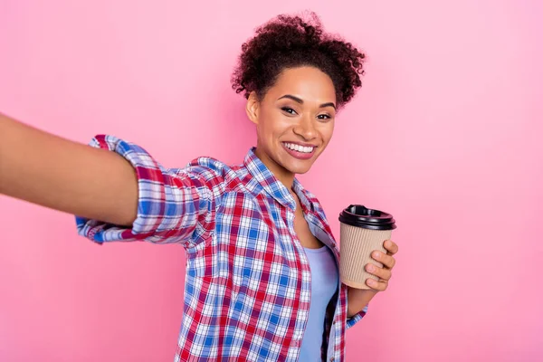 Self-portrait of attractive cheerful friendly girl wearing checked shirt drinking latte isolated over pink pastel color background — 스톡 사진