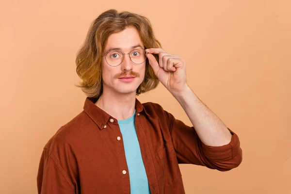 Portret van aantrekkelijke intelligente inhoud geschoolde roodharige man aanraken specs isoleren over beige pastel kleur achtergrond — Stockfoto