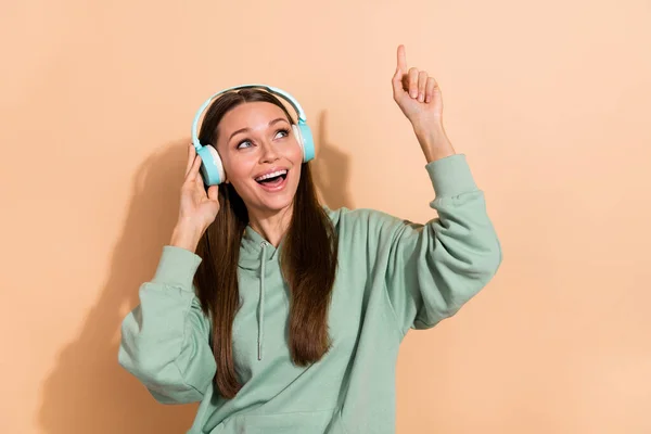 Portrait of attractive cheerful brown-haired girl listening hit single dancing having fun isolated over beige pastel color background — Stock Photo, Image