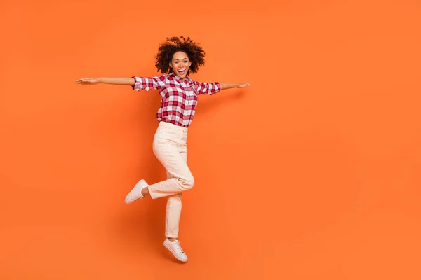 Full length body size view of attractive cheerful carefree girl jumping flying rest isolated on bright orange color background — ストック写真