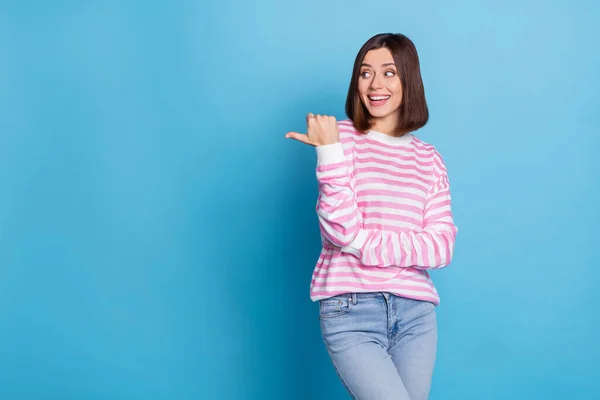 Photo of impressed young brunette lady look promotion wear sweater jeans isolated on blue background — ストック写真