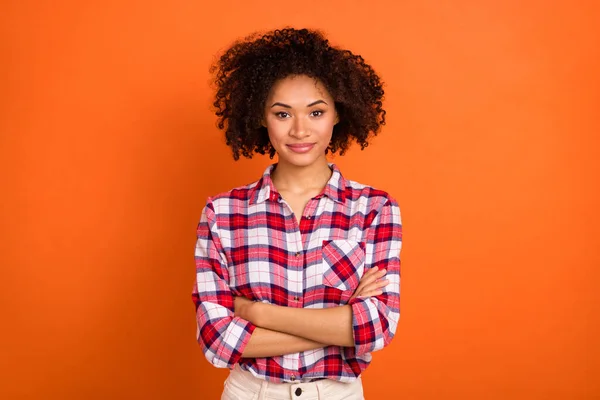 Photo of young curly lady crossed arms wear plaid shirt isolated on orange color background — 스톡 사진
