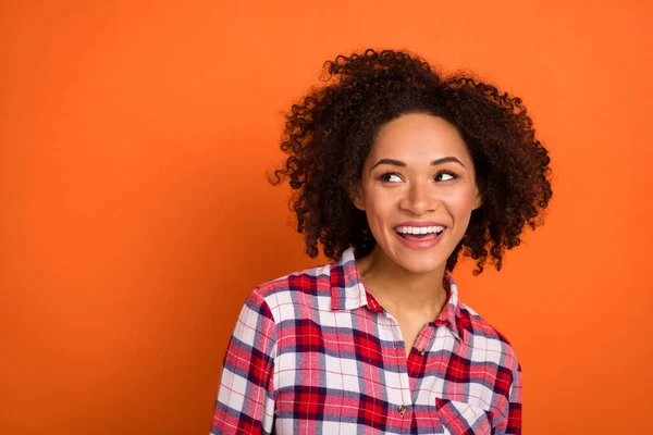 Photo of impressed millennial brunette lady look empty space wear red shirt isolated on orange color background — 스톡 사진