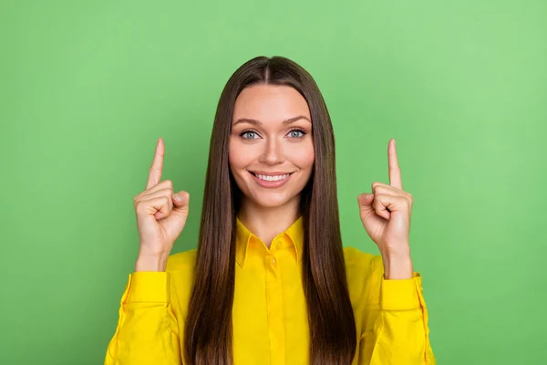 Foto de otimista jovem penteado marrom senhora índice até desgaste camisa amarela isolada no fundo de cor verde — Fotografia de Stock