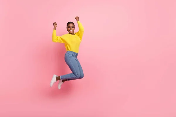 Full body profile side photo of young cheerful girl rejoice luck triumph fists hands jump isolated over pink color background — 스톡 사진