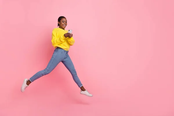 Full size profile side photo of young girl share repost mobile comment blogger jump isolated over pink color background — ストック写真