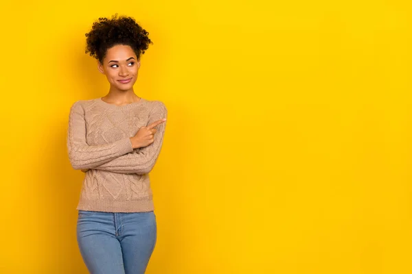 Photo of pretty dreamy lady dressed beige pullover looking pointing empty space isolated yellow color background — 스톡 사진